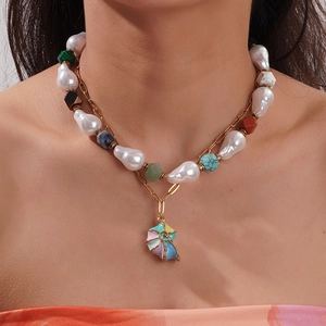 Baroque pearl necklace with colorful natural stones and shell pendant on a model