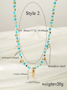 Detail of beaded evil eye necklace with stainless steel mermaid pendant and rhinestones