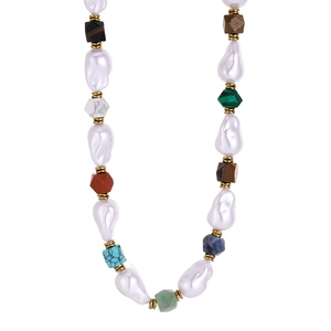 Bohemian baroque pearl necklace with natural stones and gold accents on white background