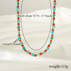 Detailed macro view of Evil Eye beaded necklace with turquoise hearts and orange agate beads