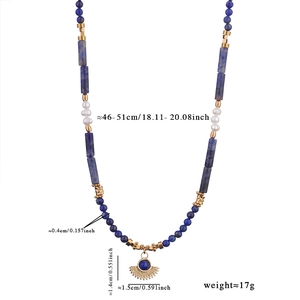 Detail of beaded lapis lazuli necklace with freshwater pearls and a fan-shaped pendant