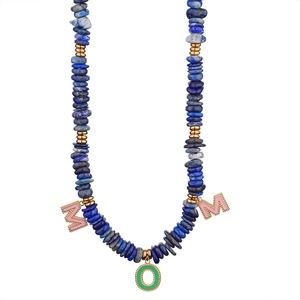 Lapis lazuli beaded necklace with MOM enamel pendants and golden spacers on white background