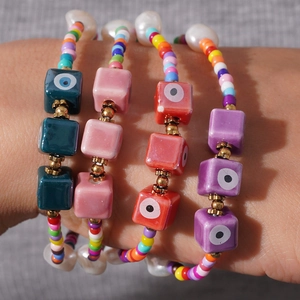 Detailed view of colorful Bohemian beaded bracelets with glass evil eye charms