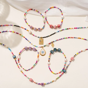 Detail of Bohemian beaded jewelry set with evil eye charms and colorful seed beads
