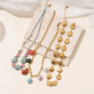 Detailed display of colorful bead necklaces with shells and skull charms on silk