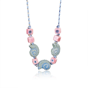 Detail of bohemian shell necklace with evil eye beads and turquoise spiral pendants