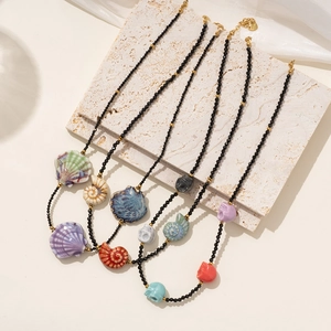 Colliers en perles noires facettées avec pendentifs colorés en forme de coquillage et crâne