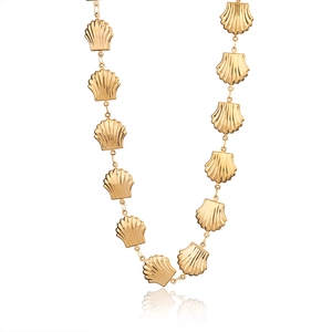 Detailed close-up of vintage gold conch shell link necklace on white background