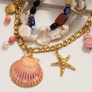 Bohemian gold chain necklace with pink shell and starfish pendants on natural stones