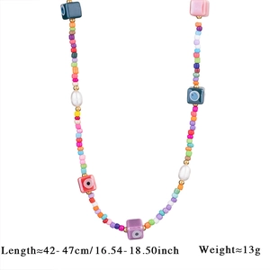 Detail of colorful beaded necklace with evil eye charms and pearls, 42-47cm length