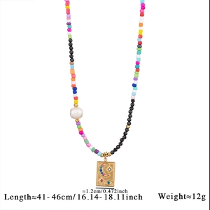 Detail of bohemian colorful bead necklace with gold celestial evil eye pendant