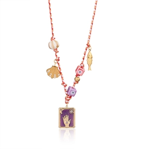 Detail of bohemian rope necklace with evil eye pendants and tarot enamel charm