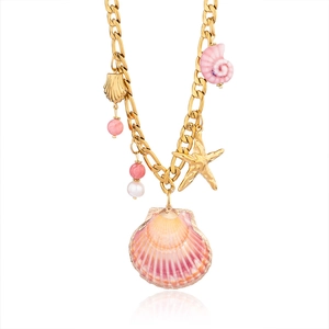 Detail of a gold Figaro chain necklace featuring large seashell and starfish charms