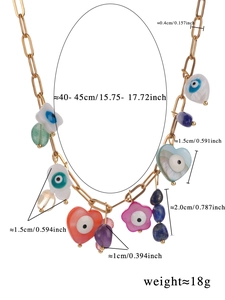 Detailed view of bohemian beaded necklace with evil eye and natural stone charms
