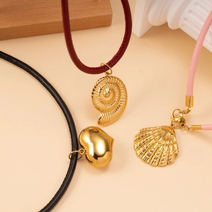 Three leather necklaces with gold shell and heart pendants in red, black and pink
