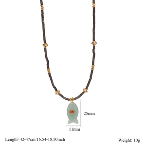 Detailed view of fish-shaped green stone pendant with dimensions and black bead chain