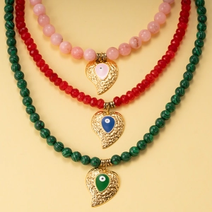 Colorful beaded necklaces with malachite beads and gold heart evil eye charms