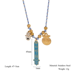 Detail of stainless steel Hamsa Hand and Evil Eye pendants on a woven chain necklace