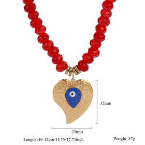 Detail of red beaded necklace with golden heart-shaped Evil Eye pendant and dimensions