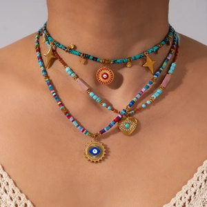 Bohemian multi-layer beaded necklace with evil eye and star charms on a model