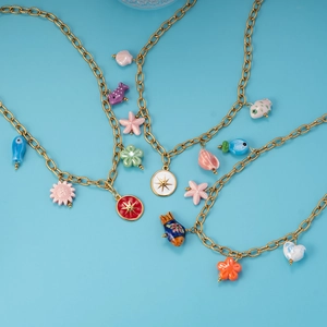 Golden stainless steel necklaces featuring colorful sea stars and fish charms on blue
