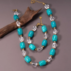 Turquoise and clear beaded necklace and bracelet set with golden heart charms