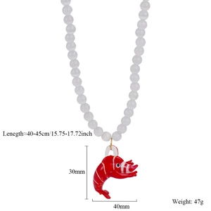 Detail view of cat eye stone bead necklace with red lobster pendant and dimensions