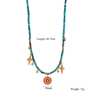 Detailed view of beaded necklace with evil eye sun disc and gold star pendants