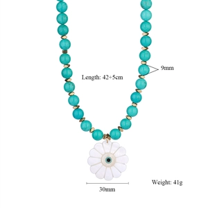 Close-up of beaded necklace with 30mm shell flower pendant and evil eye design