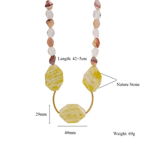 Detailed view of handmade beaded necklace with natural stones and gold metal ring