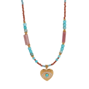 Detail of beaded necklace with turquoise evil eye heart pendant in gold finish