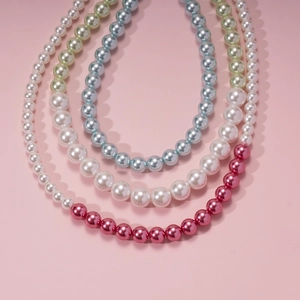 Colorful pearl necklace set featuring pink green blue and white iridescent luster beads