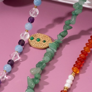 Handmade beaded necklace with natural colorful gemstones and a gold textured metal pendant