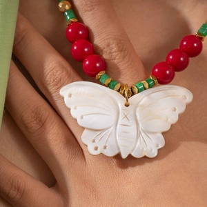 Vintage beaded necklace with a white butterfly shell pendant and colorful ethnic beads