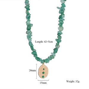 Detail of bohemian crushed green stone necklace with 20mm textured golden pendant