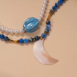 Double-layer necklace with blue lapis beads, pearls and a large moon shell pendant