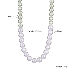 Detail view of 8mm green and 10mm white pearls on a 40cm adjustable necklace