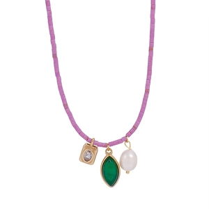 Detail of beaded necklace with purple beads, green gemstone, and freshwater pearl charms
