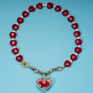 Vintage heart necklace with red beads, white pearls, and large floral resin heart pendant
