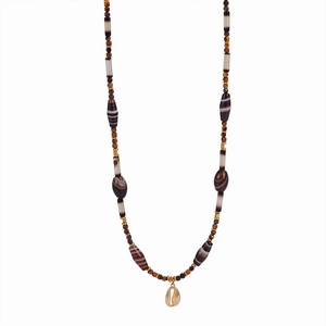Long beaded necklace with brown agate cylinders and a gold-tone shell pendant