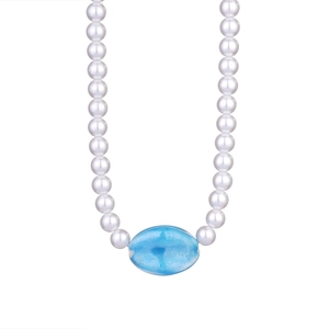 Detail of beaded necklace with white pearls and a large oval blue resin pendant charm
