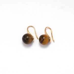 Macro detail of natural tiger eye stone earrings with elegant gold-plated hooks