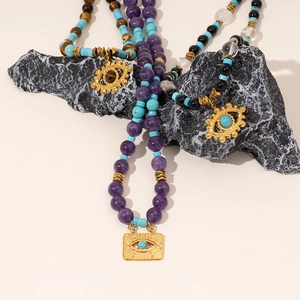 Bohemian beaded necklace featuring turquoise, tiger eye stones and a golden Evil Eye pendant