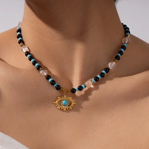 Boho Evil Eye necklace with tiger eye beads and turquoise accents on a female model
