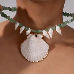 Natural green aventurine beaded necklace with large gold-edged shell pendant and blue crystal