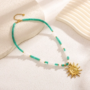 Handmade stainless steel beaded necklace with sun pendant and green natural stones