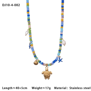 Detail view of 40+5cm stainless steel beaded necklace with turtle and shell charms