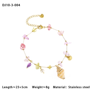 Detail showing natural seashell pendant with colorful beads on a gold chain anklet