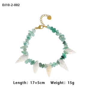 Green natural stone beads and shell pendants on a bohemian bracelet with golden clasp