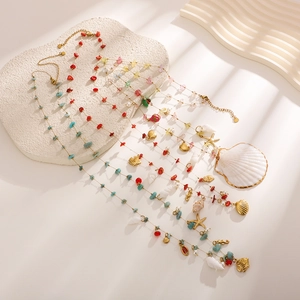 Boho layered body chain with natural stones, sea shells and starfish charms in gold finish